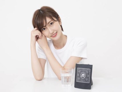 テーブルに置かれているくろしろと微笑む女性