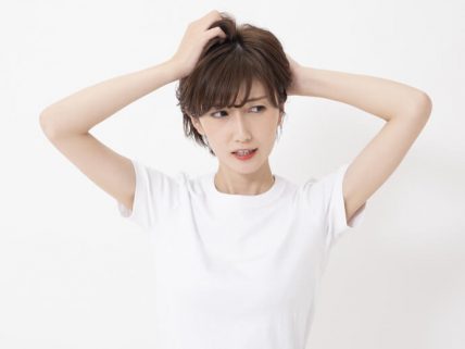 悩んで頭を抱える女性